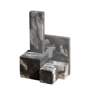 Set of four gray marble cube blocks on a white background